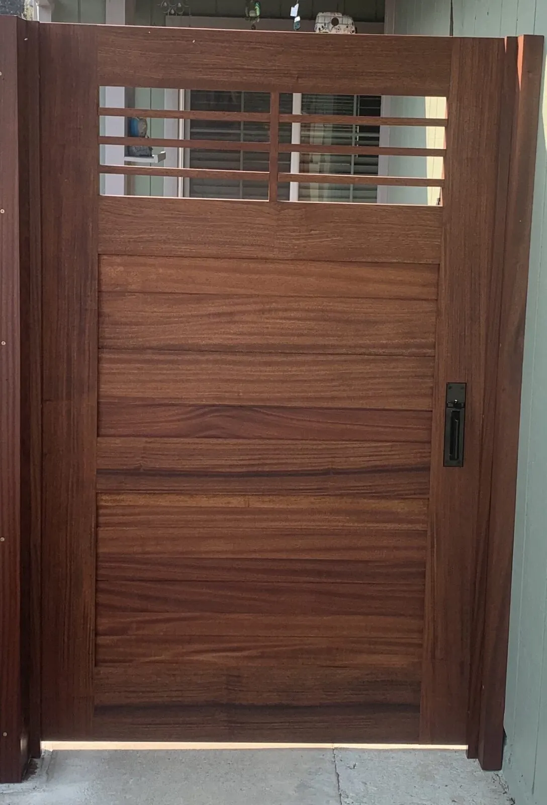Tall mahogany craftsman side-yard gate with horizontal slat panel and divided-light top