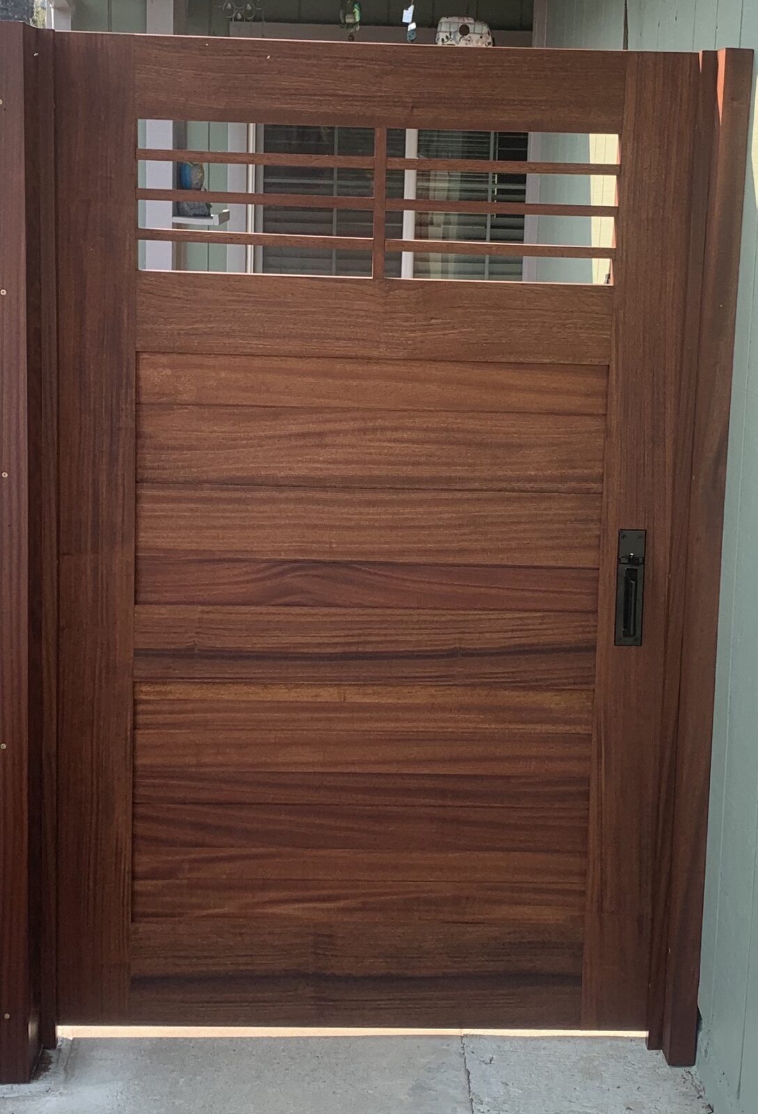 Tall mahogany craftsman side-yard gate with horizontal slat panel and divided-light top