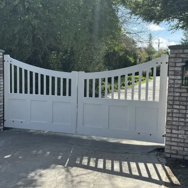 White painted double swing gate with vertical pickets and panel base