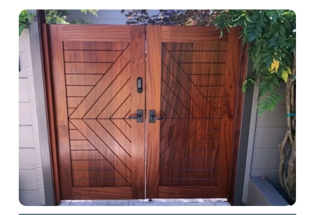 Double pedestrian gate in mahogany with carved chevron pattern and keypad lock